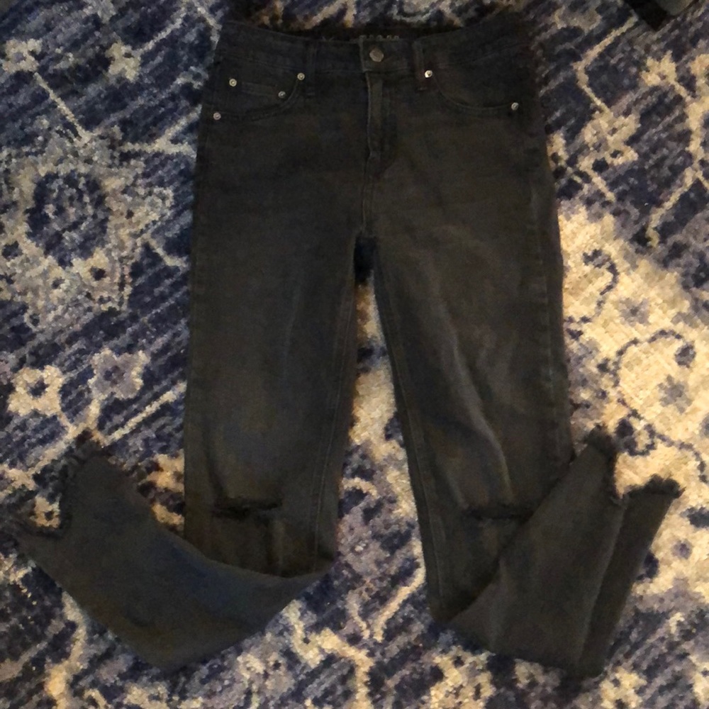 Black skinny jeans with rips in both knees